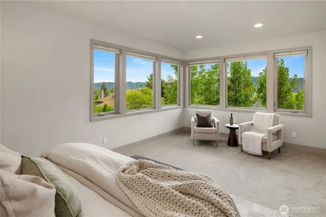 a bedroom with furniture and a large window