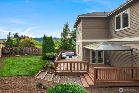 a view of a roof deck with a barbeque grill with wooden fence