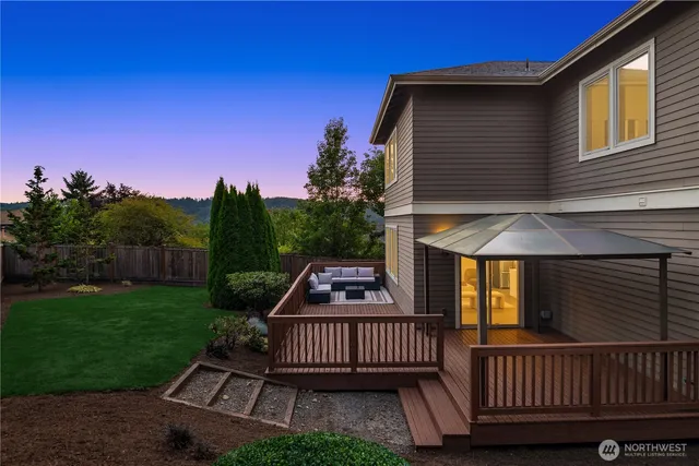 a view of a roof deck with chair and garden