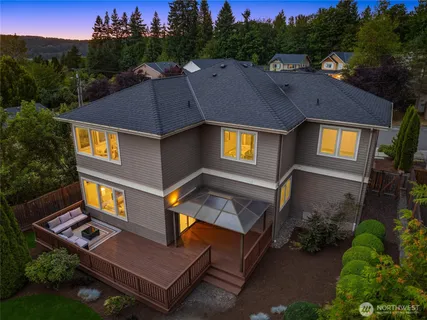 an aerial view of a house with swimming pool and a yard