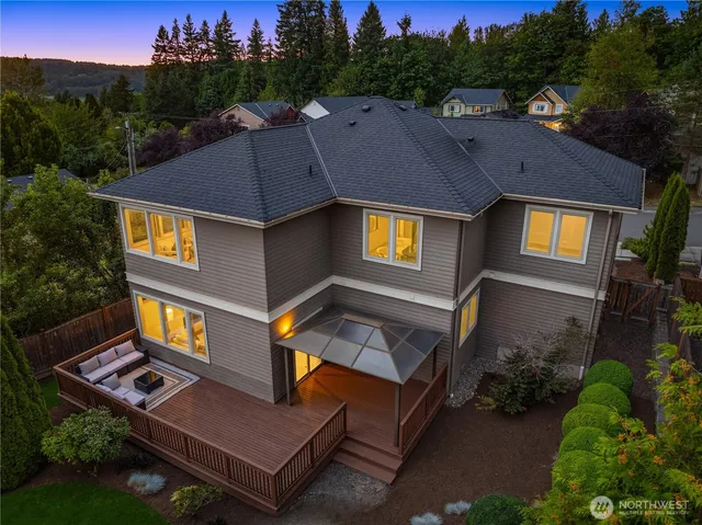 an aerial view of a house with swimming pool and a yard