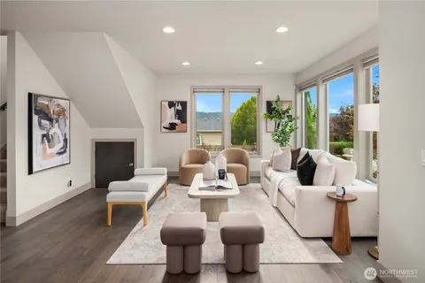 a living room with fireplace furniture and a large window