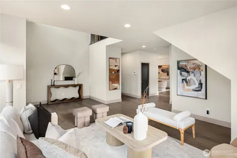 a living room with furniture and painting on the wall