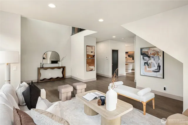 a living room with furniture and painting on the wall