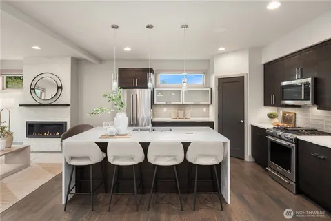 a view of kitchen with sink dining table and chairs