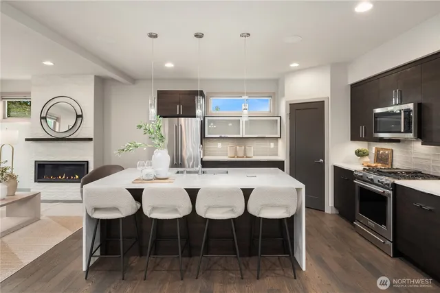 a view of kitchen with sink dining table and chairs