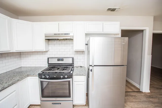 a stove top oven sitting inside of a kitchen
