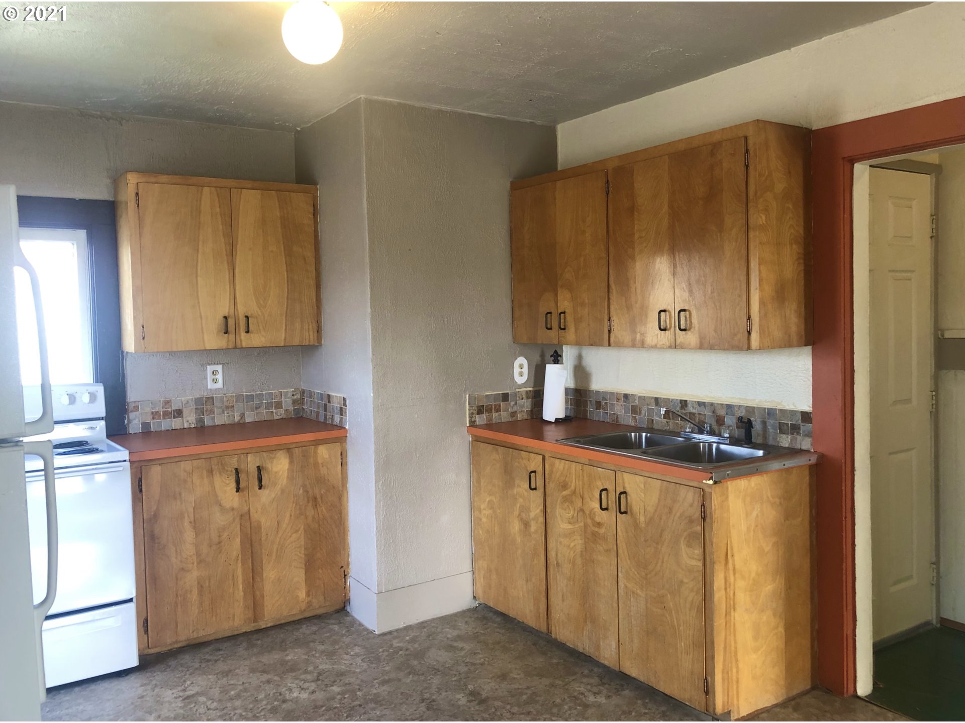 602 South Main Street Pendleton, OR 97801 - Photo 15 of 26 a kitchen with stainless steel appliances granite countertop a stove a sink and a refrigerator with wooden cabinets