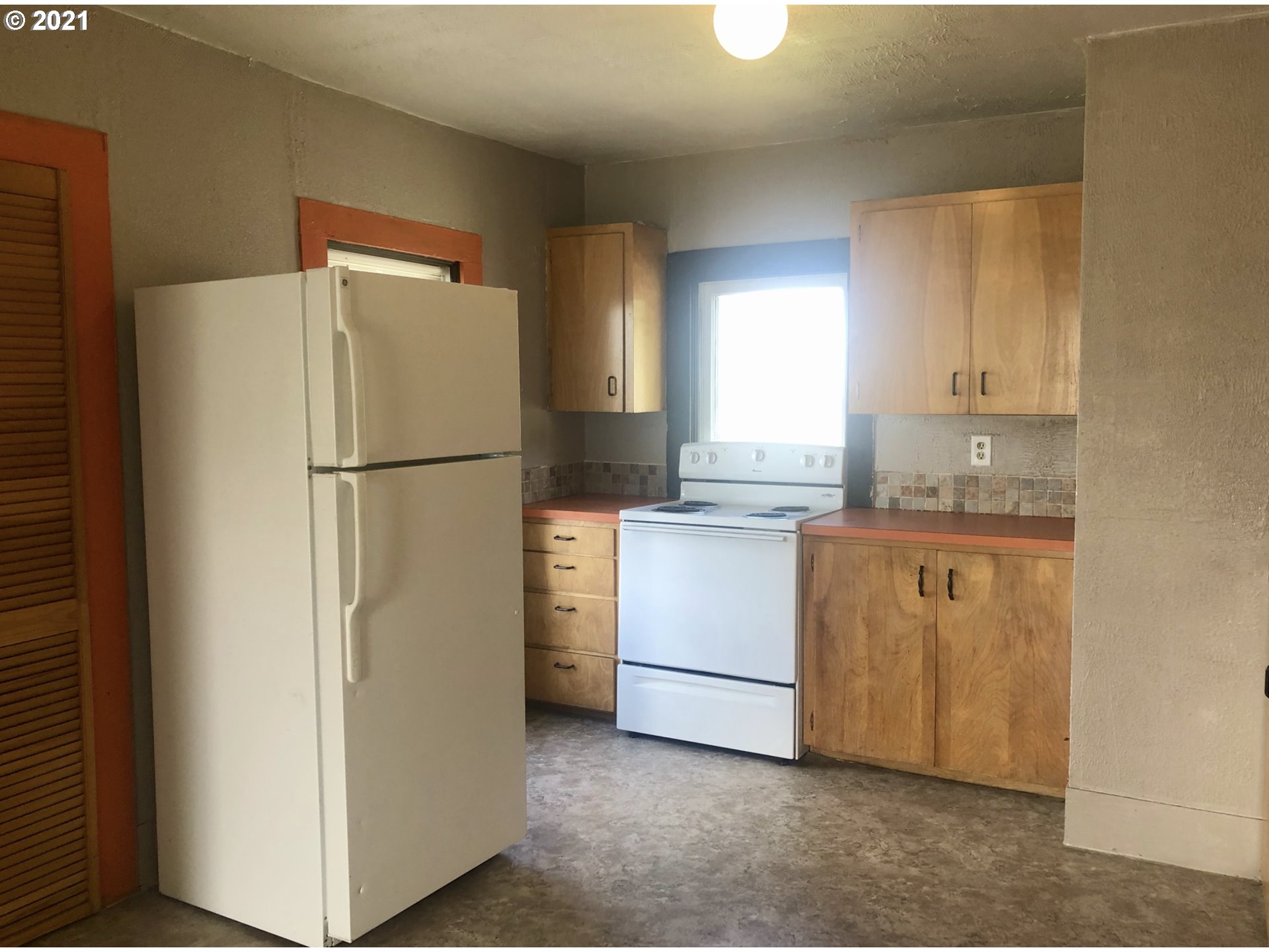 602 South Main Street Pendleton, OR 97801 - Photo 16 of 26 a kitchen with white cabinets and white appliances