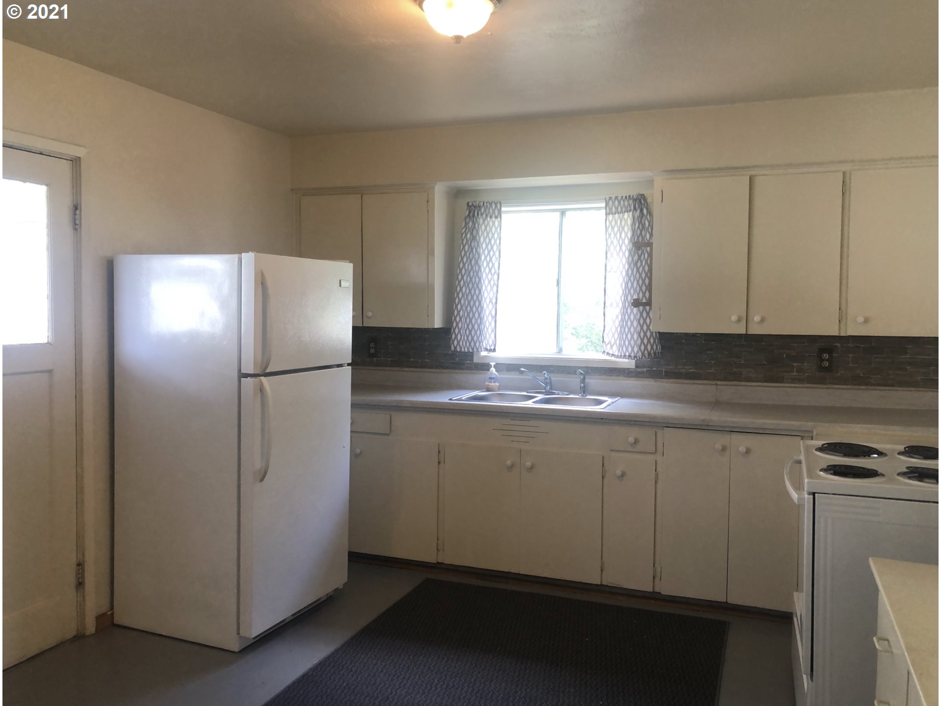 602 South Main Street Pendleton, OR 97801 - Photo 5 of 26 a kitchen with a refrigerator and a sink