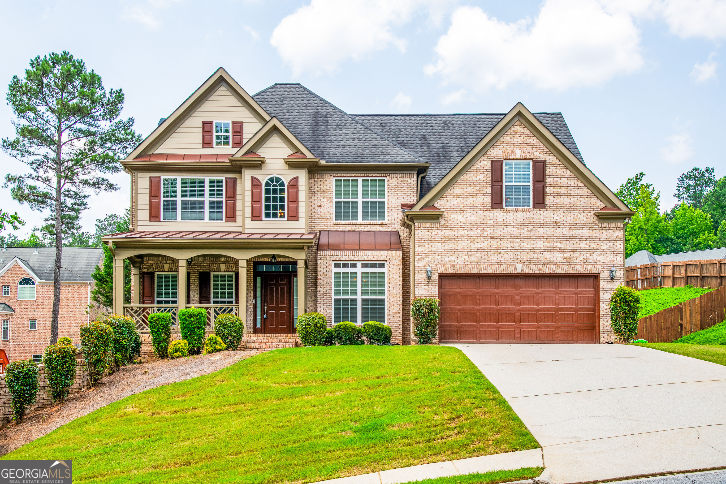 a front view of a house with a yard and garage