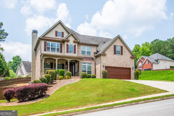 a front view of a house with a garden