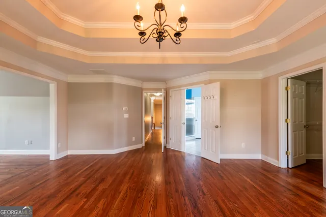 a view of a room with wooden floor