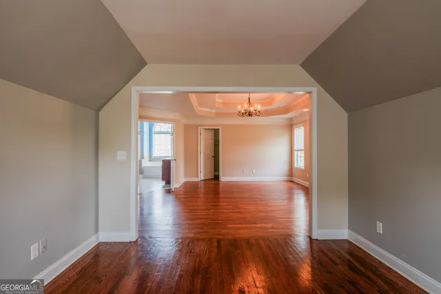 a spacious bathroom with a mirror a bathtub and a shower