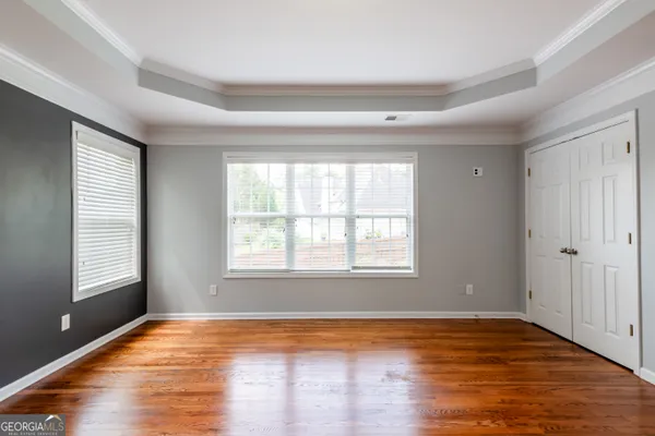 a view of a hallway with furniture and a chandelier