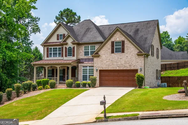 a front view of a house with a yard and garage