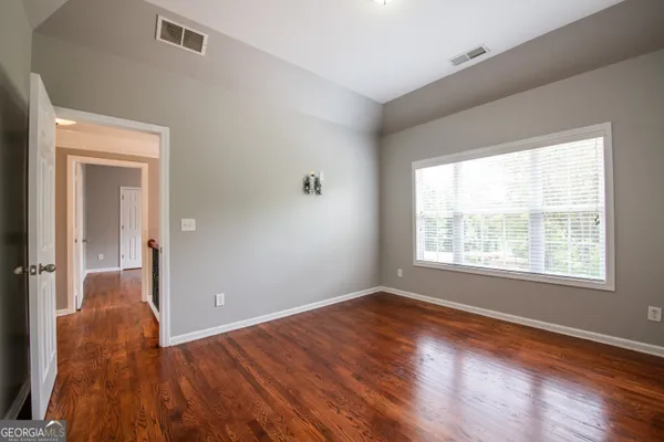 a bathroom with a sink a toilet and a large mirror