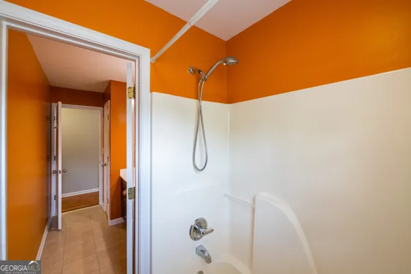 a view of a hallway with windows and chandelier