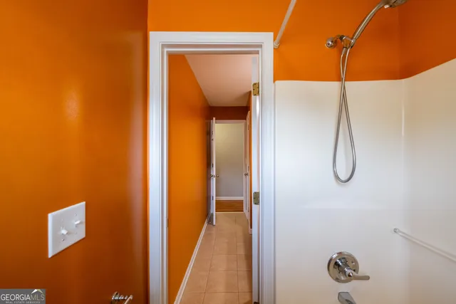 a spacious bathroom with a tub sink and mirror