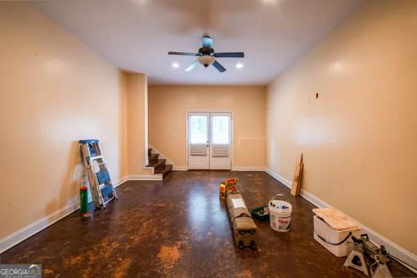 a room with gym equipment and windows
