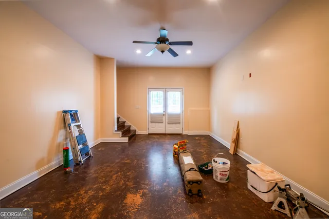 a room with gym equipment and windows