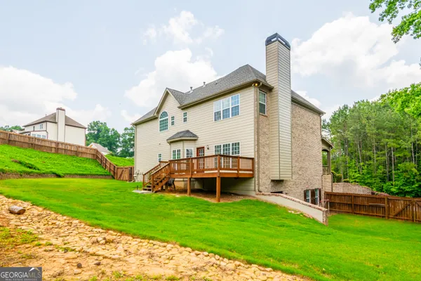 a view of a house with backyard and sitting area