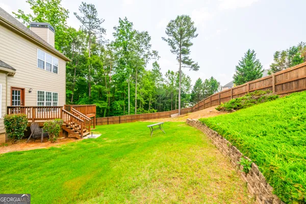 a view of a backyard with swimming pool