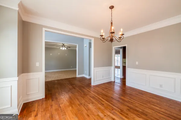 a view of a room with wooden floor staircase and a living room