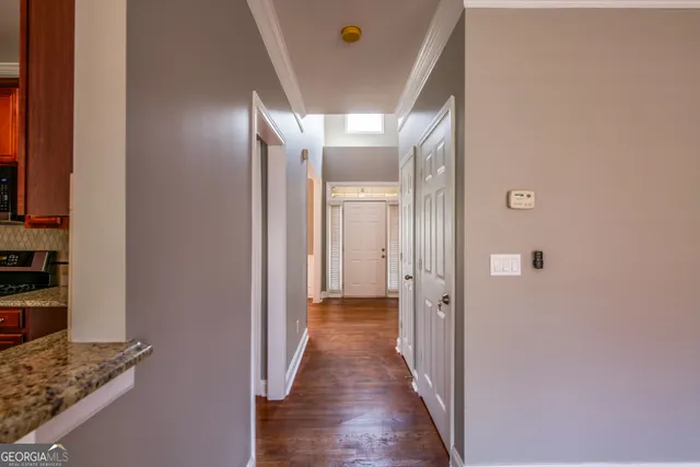 a view of a hallway with wooden floor