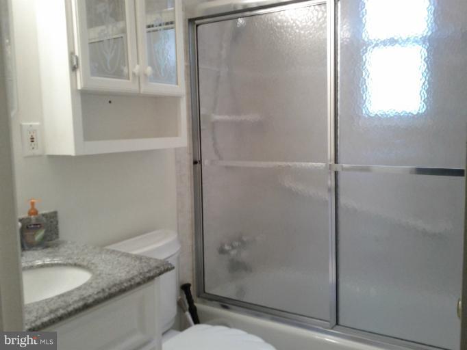 3611 Adams Drive Silver Spring, MD 20902 - Photo 2 of 16 a bathroom with a granite countertop shower and a sink