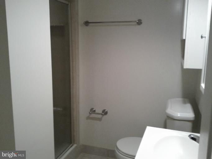 3611 Adams Drive Silver Spring, MD 20902 - Photo 12 of 16 a white toilet sitting next to a shower
