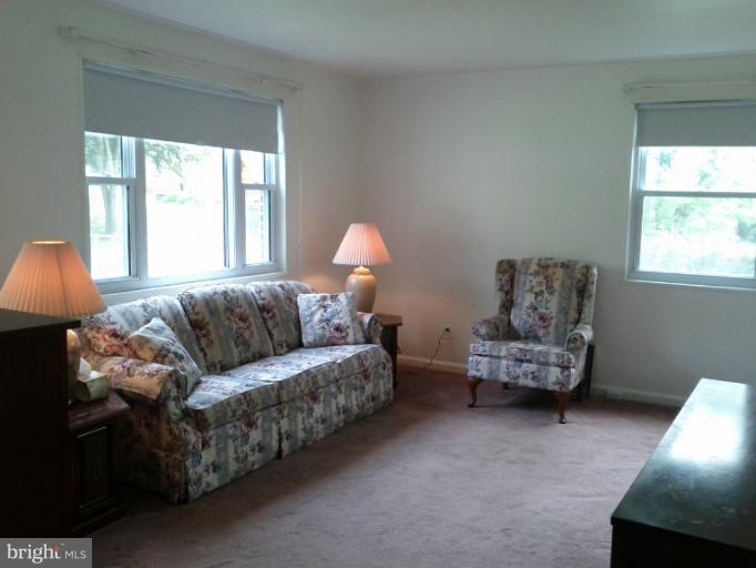 3611 Adams Drive Silver Spring, MD 20902 - Photo 14 of 16 a living room with furniture a window and a lamp