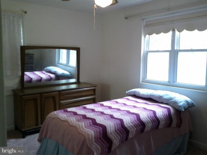 3611 Adams Drive Silver Spring, MD 20902 - Photo 15 of 16 a bedroom with a bed and a window