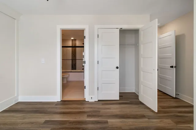 a view of a livingroom with wooden floor and closet