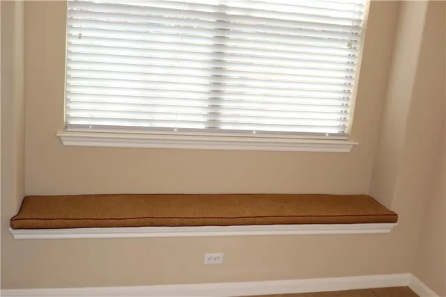 a view of a livingroom with a fireplace and window