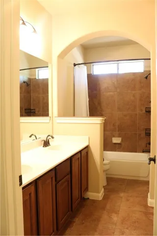 a view of an empty room with wooden floor and cabinet