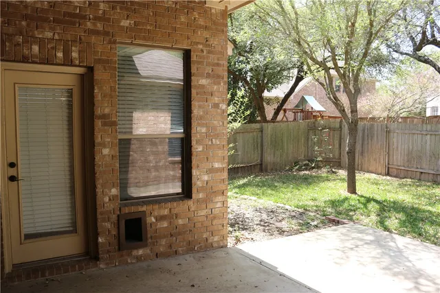 a backyard of a house with barbeque oven