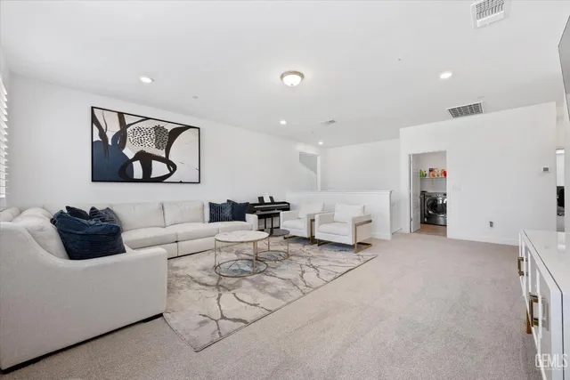 a living room with furniture and white walls