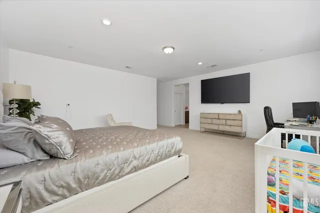 a bedroom with a bed and a television