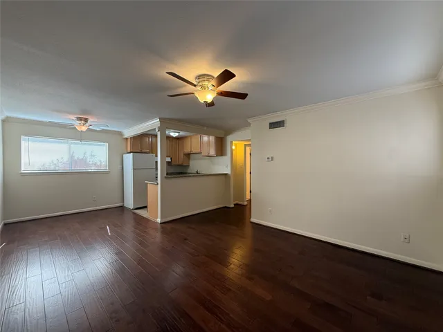 a kitchen with stainless steel appliances a refrigerator and a stove top oven