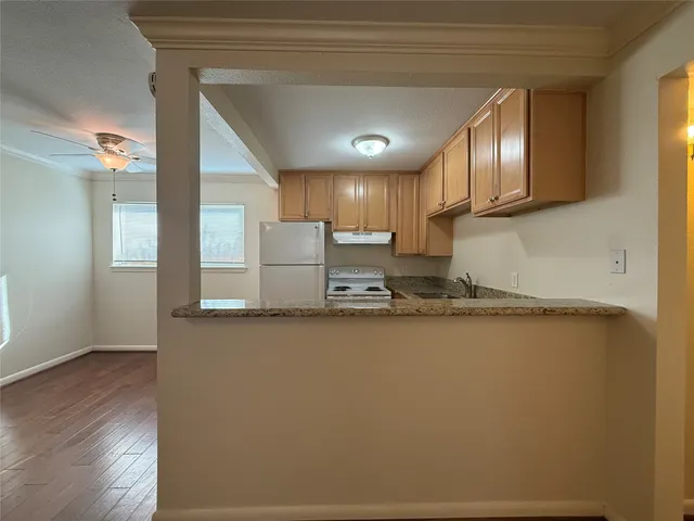 a kitchen with a refrigerator sink and cabinets