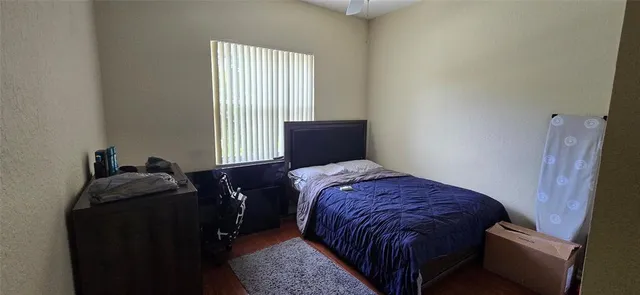a bed sitting in a bedroom next to a window