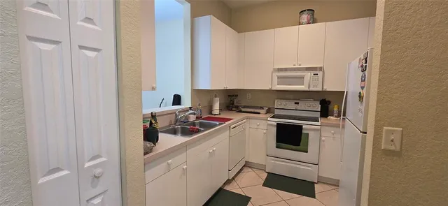 a kitchen with a sink and a stove top oven
