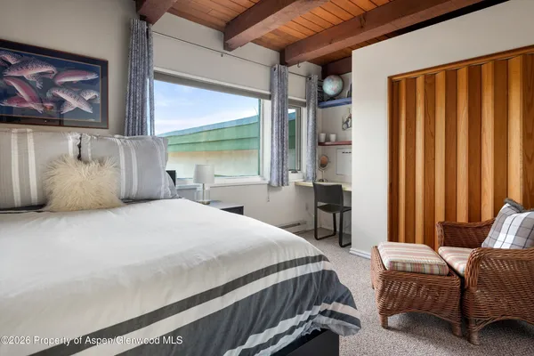 a bedroom with a large bed and a window