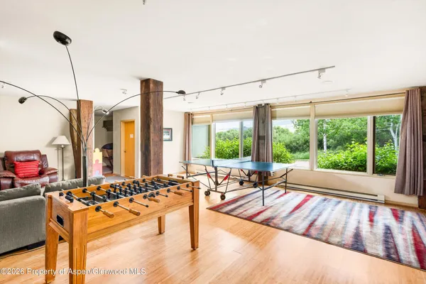 a living room with furniture and floor to ceiling windows