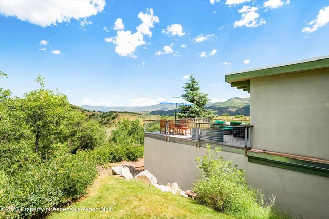 a view of a patio with table and chairs and potted plants