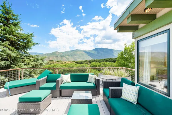 a view of a chairs in back yard of the house