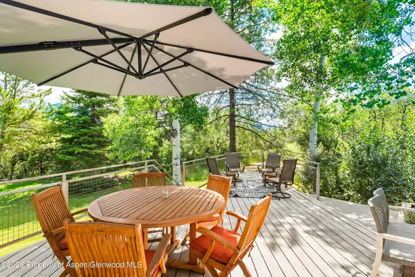 a view of a chair and table on the deck
