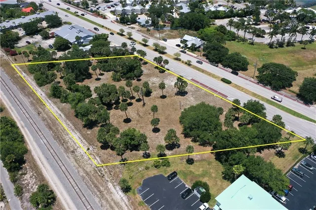 an aerial view of a house with a yard and greenery