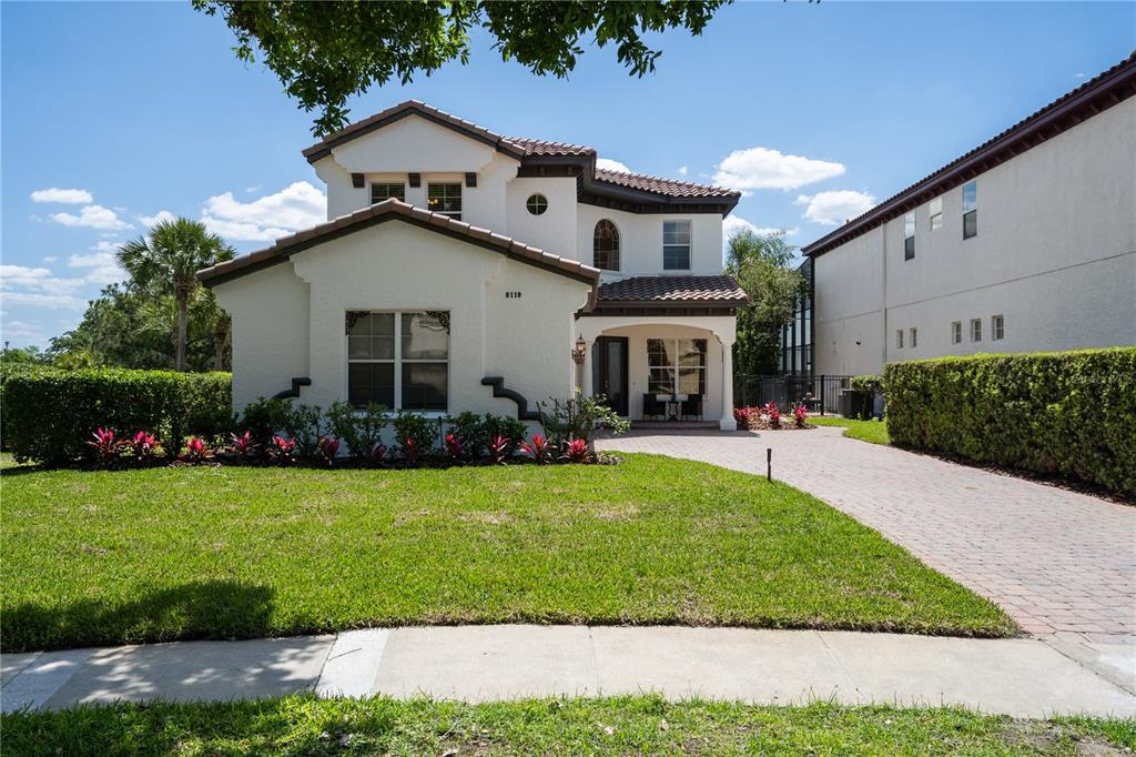 8119 Vía Rosa Orlando, FL 32836 - Photo 57 of 62 a front view of a house with plants and garden